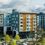 Multi-Family Housing in Seattle's Yesler Terrace. A park is in the foreground and white fluffy spring clouds are in the top of the photo.